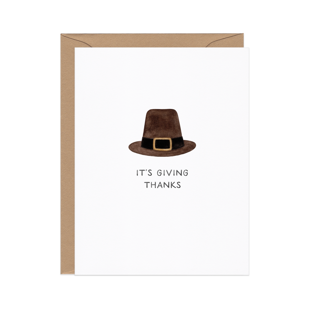 Greeting card with a brown watercolor pilgrim hat with a gold buckle, IT'S GIVING THANKS below, and a kraft envelope behind