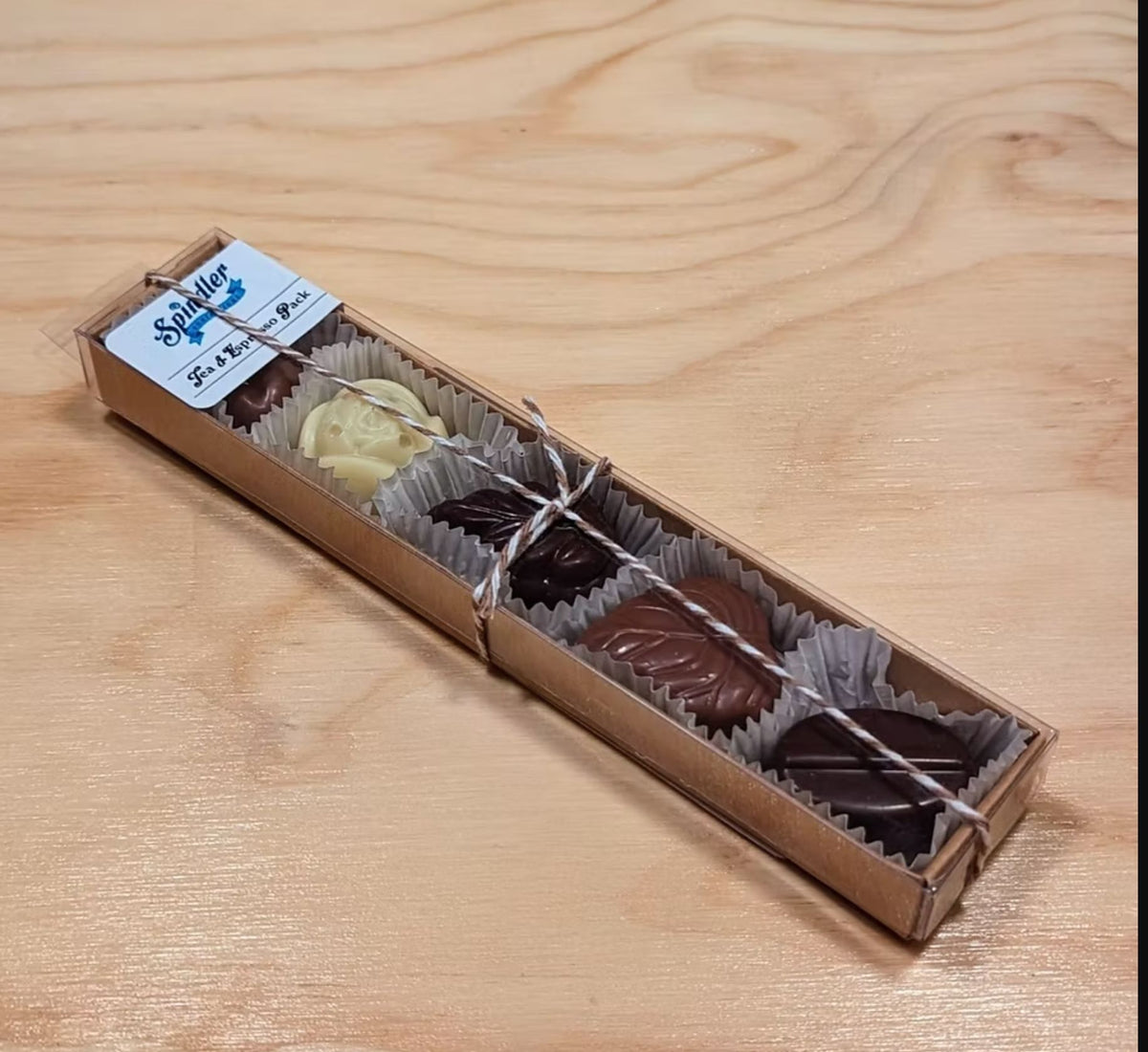 Spindler Tea and Espresso Pack: five chocolate tea leaf and espresso bean candies in a kraft sleeve with red and white twine