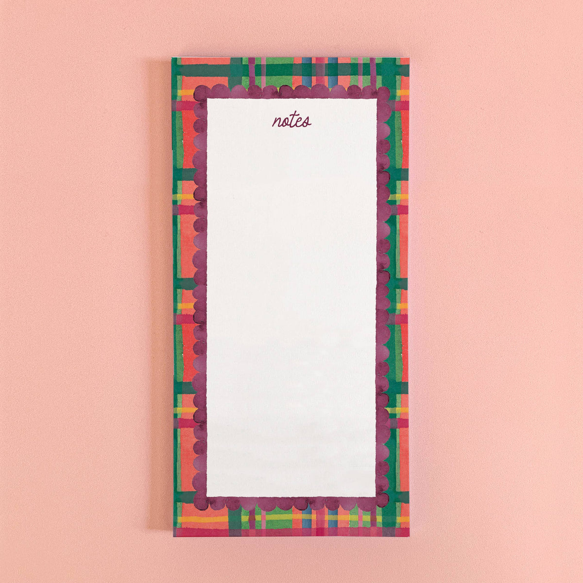 Holiday Plaid notepad with notes in script at the top, in a red, green and pink plaid border with a plum scalloped edge