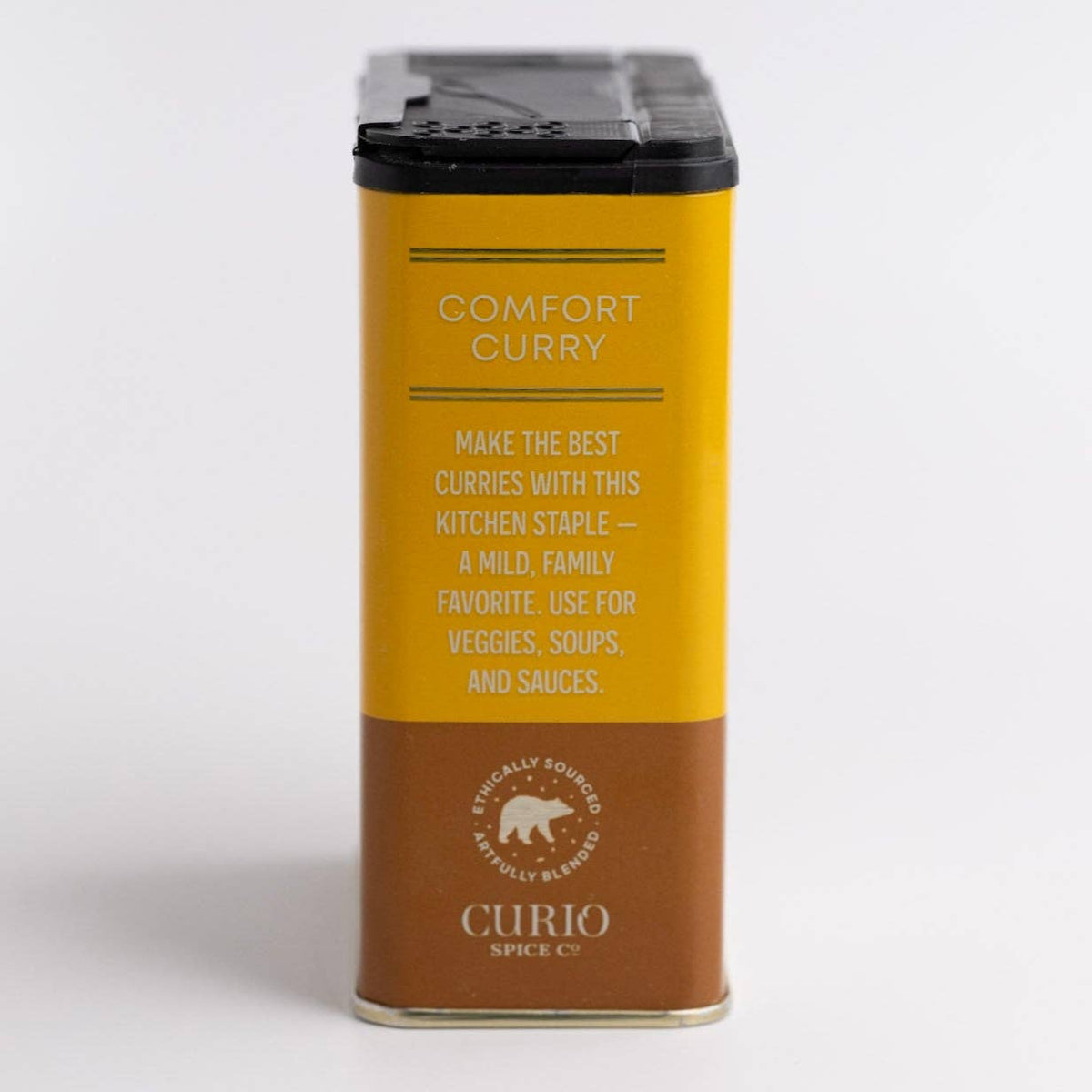 Side of the Comfort Curry tin with copy calling it a mild, family favorite for veggies, soups and sauces