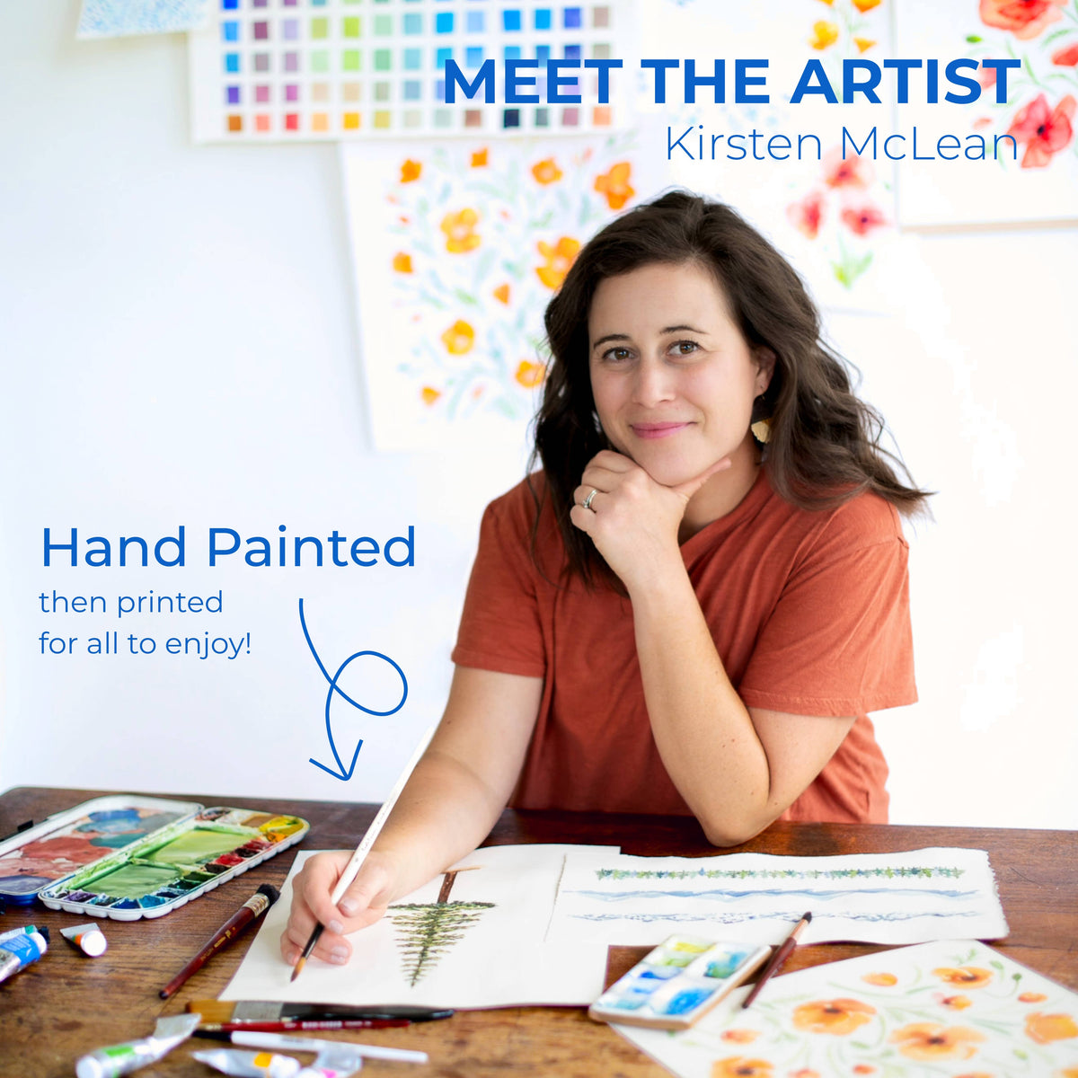 Watercolor Wednesday artist Kirsten McLean painting a pine tree at her desk, surrounded by watercolor palettes and floral artwork, with Hand Painted then printed for all to enjoy text
