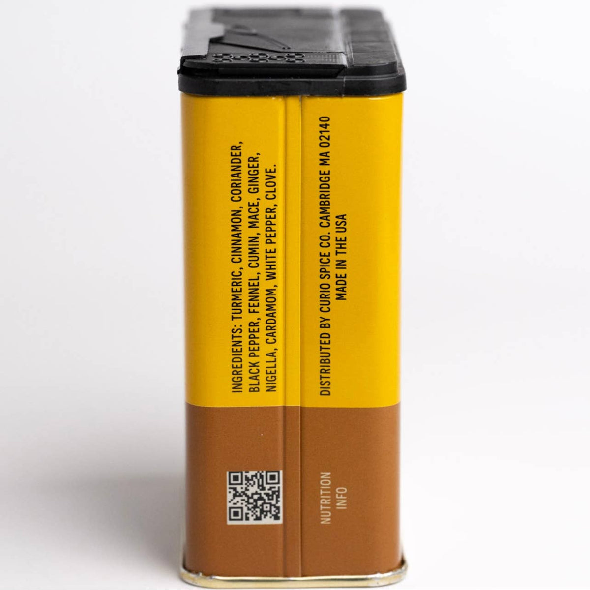 Side of the Comfort Curry tin listing ingredients: turmeric, cinnamon, coriander, pepper, fennel, cumin, ginger and more