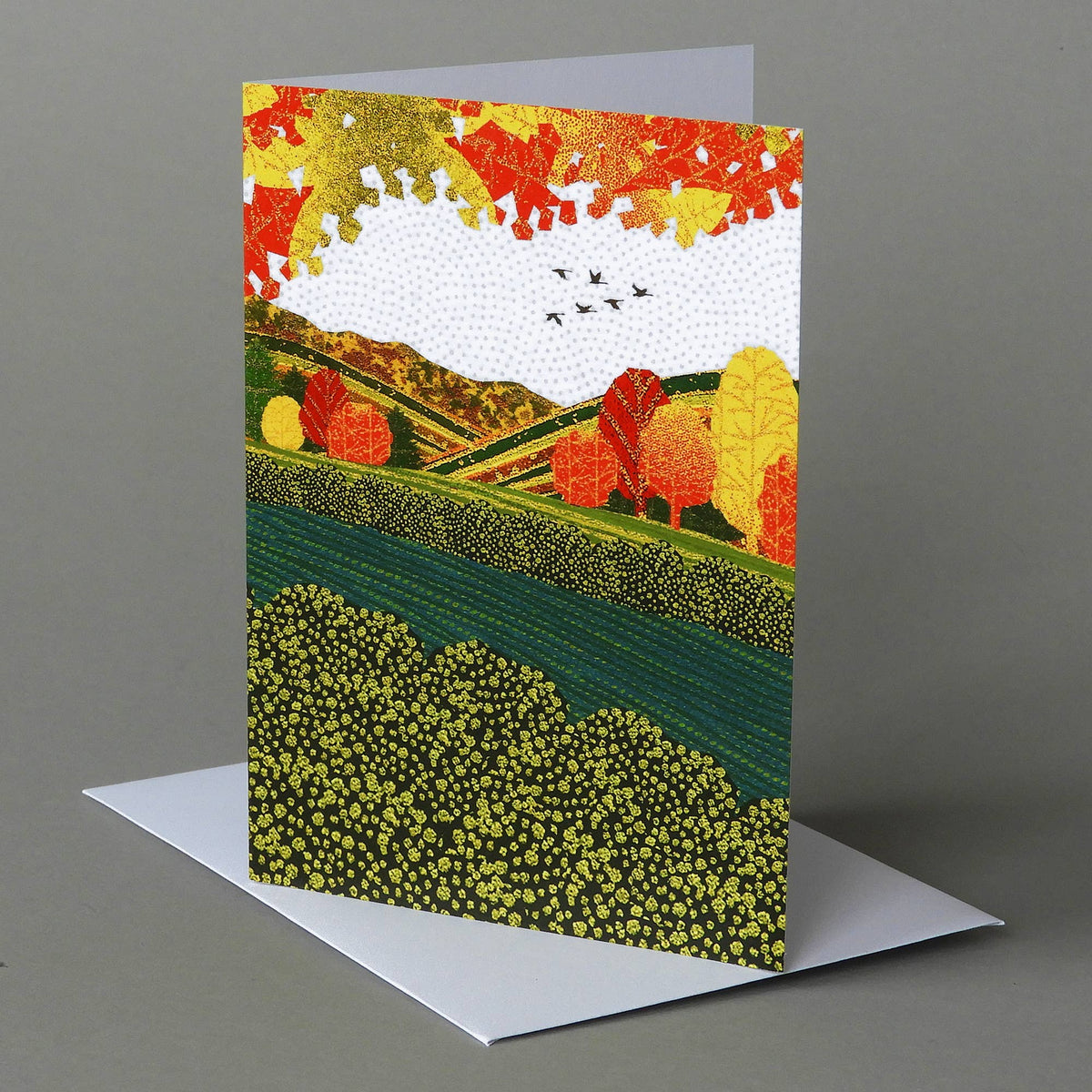 Autumn River notecard of a teal river between green banks and orange autumn trees with a flock of birds above
