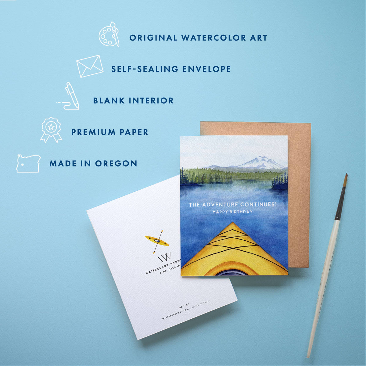 Kayak Birthday Card feature list showing original watercolor art, self-sealing envelope, blank interior, premium paper, and made in Oregon, with the card and kraft envelope and a paintbrush