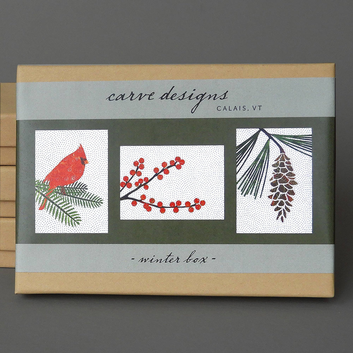 Winter Box of 10 blank notecards, a kraft box with a gray band showing cardinal, winterberry and white pine card designs