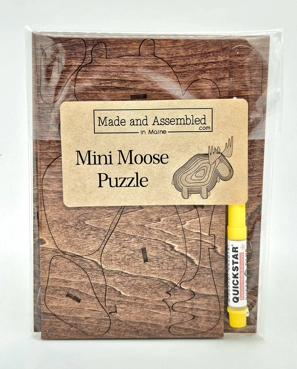 Mini Moose Puzzle in a clear bag with a kraft label and yellow glue pen, brown stained wood pieces still in the sheet
