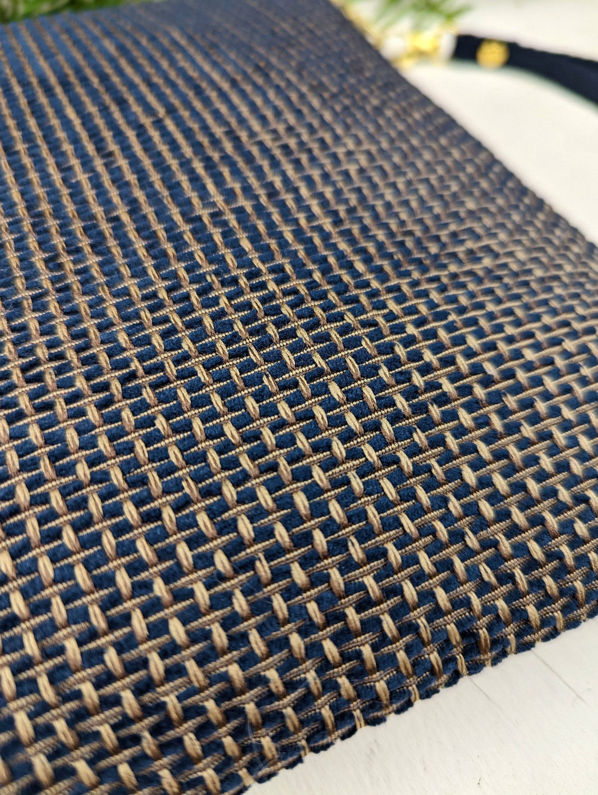 Close-up of the Golden Navy Tweed wristlet purse fabric, a navy and gold basketweave pattern, with the navy strap visible