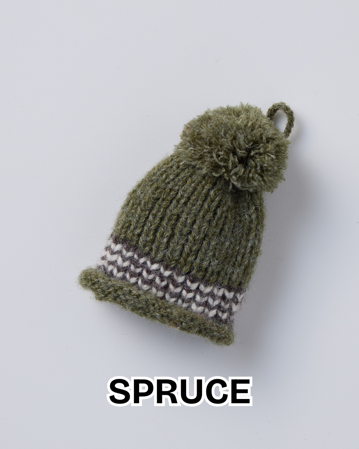 Spruce green knit hat ornament with a pom-pom and a striped brim