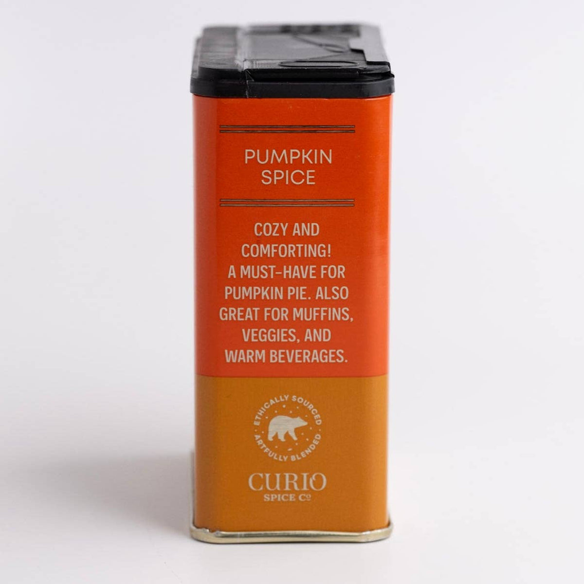 Side of the Curio Pumpkin Spice tin with copy calling it cozy and comforting for pumpkin pie, muffins and warm beverages