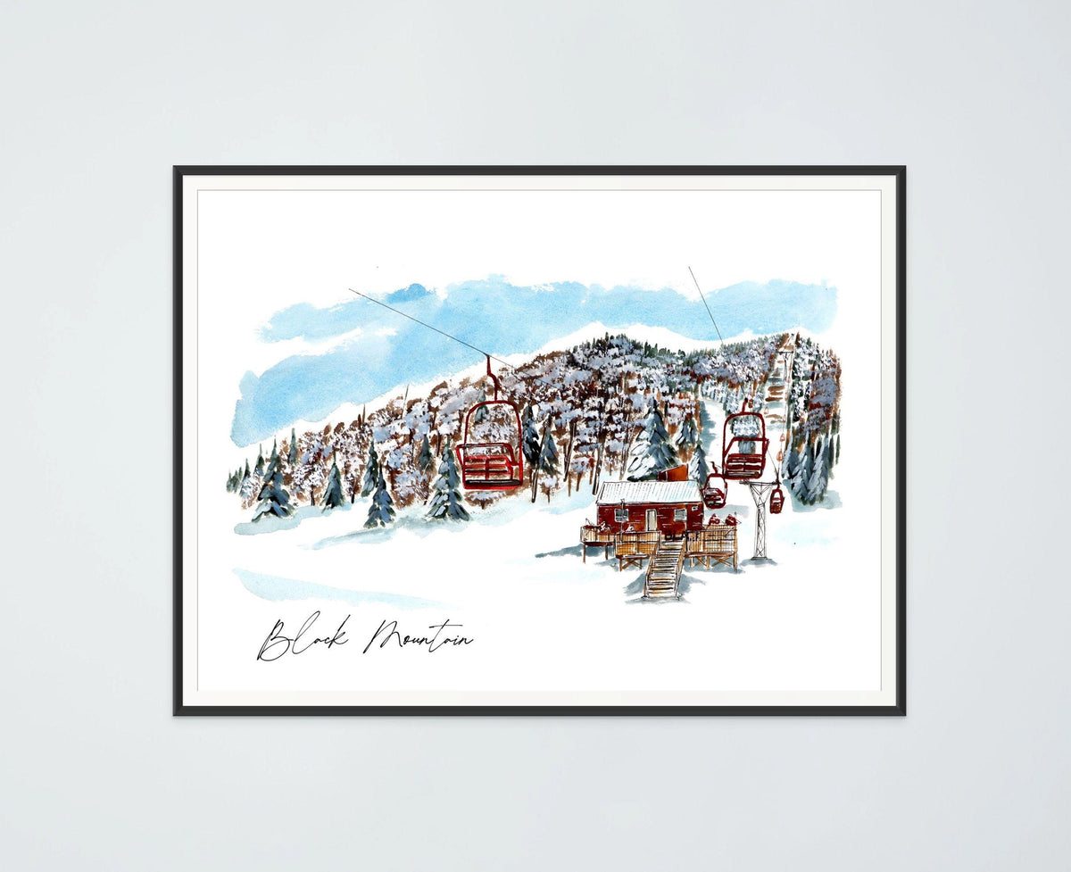 Black Mountain print in a black frame, hung on a plain wall