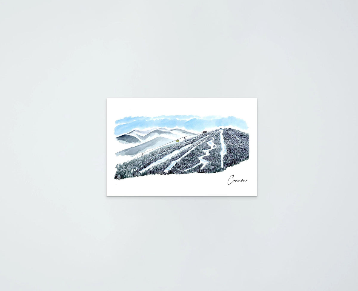 Cannon Mountain watercolor art print — ski trails cutting through forested slopes with a lift station at the ridge, distant mountain range behind, signed "Cannon" by the artist