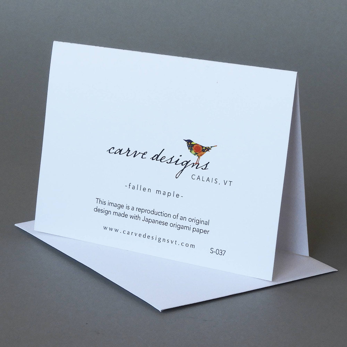 Back of the Fallen Maple notecard with the Carve Designs bird logo, Calais VT, and origami paper reproduction note