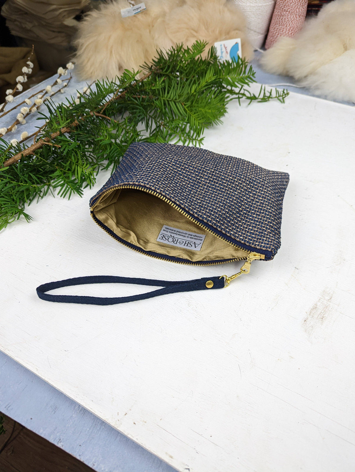 Close-up of the Golden Navy Tweed wristlet purse fabric, a navy and gold basketweave pattern