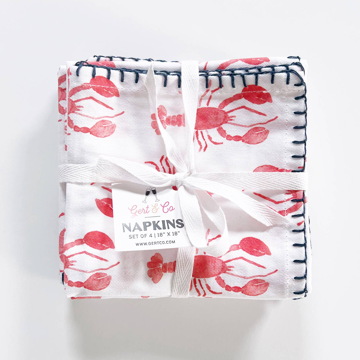 Set of four lobster napkins tied with white twill ribbon and a Gert & Co tag reading Napkins, set of 4, 18 by 18