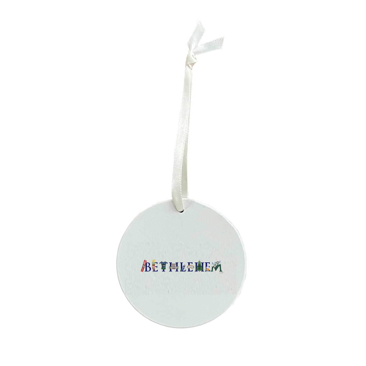 Round white ceramic ornament with a white ribbon hanger, printed with the word BETHLEHEM in navy letters decorated with tiny illustrations of skis, an ice cream cone, a pine tree and mountains