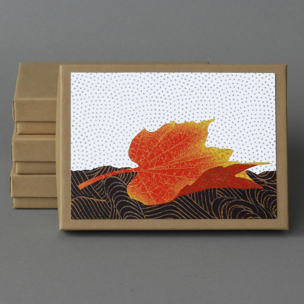 Fallen Maple Box of 10 blank cards, a kraft box with a lone orange maple leaf on dark swirled paper on the lid