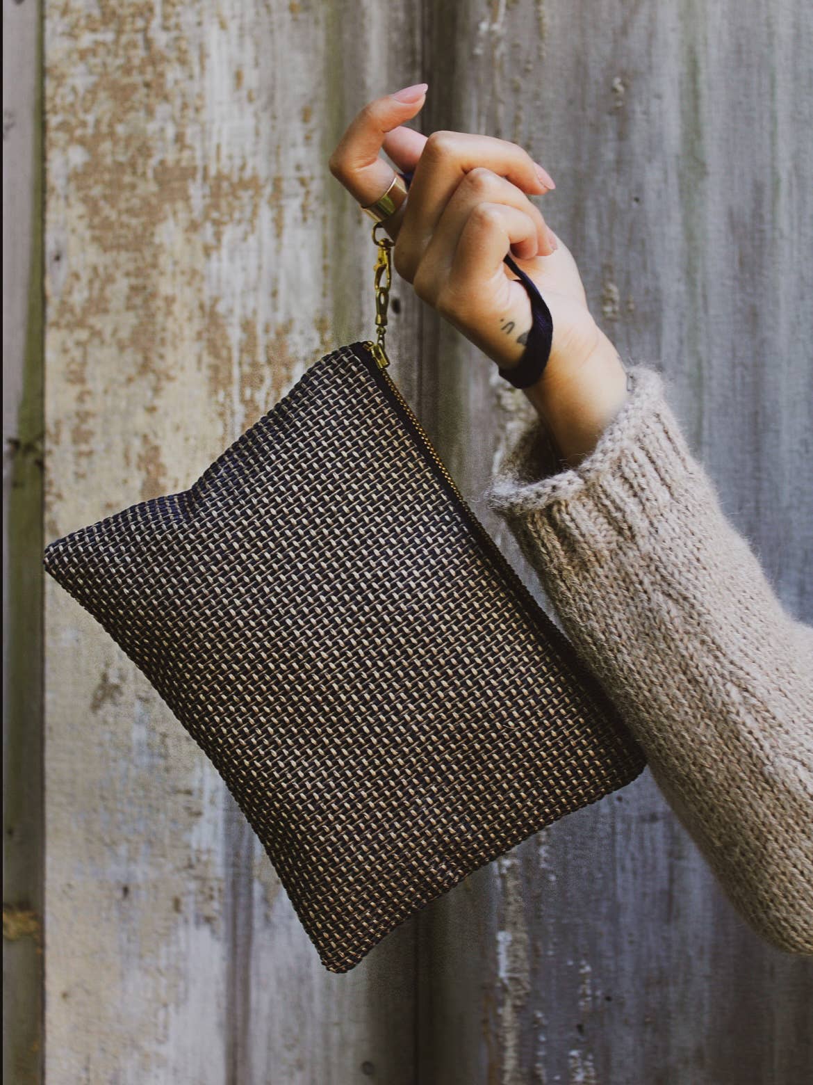 Open Golden Navy Tweed wristlet purse showing a gold lining and the Ash & Rose label, navy and gold basketweave exterior
