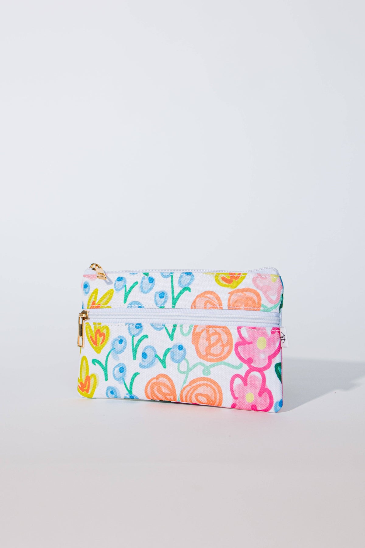 Lauren Floral Pencil Pouch angled view showing both zippered pockets with pink and orange roses, yellow tulips, and blue berries on white canvas