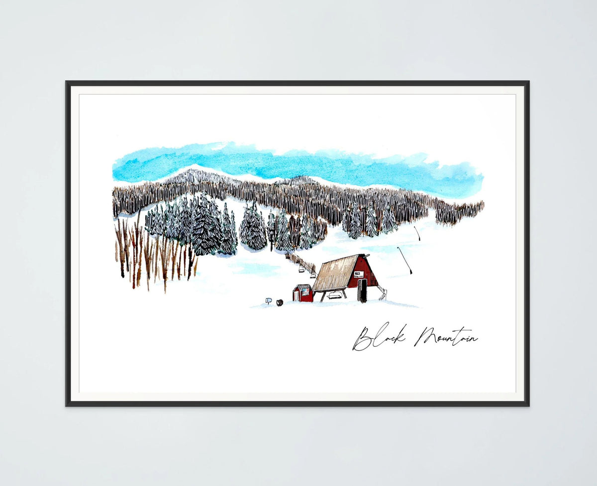 Black Mountain Ski Area print in a black frame, hung on a plain wall